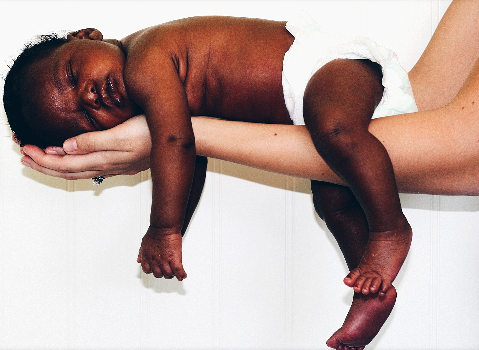 race and adoption blog photo of a black infant being held in a caucasian woman's arms